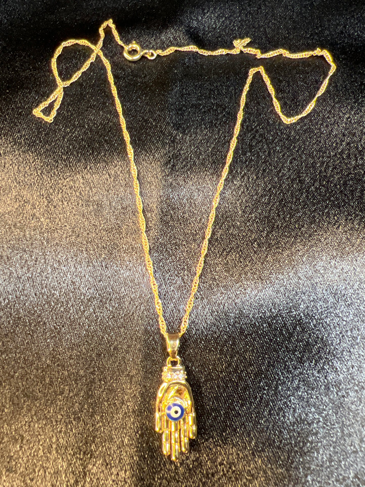 Gold Hand Holding the Evil Eye Necklace